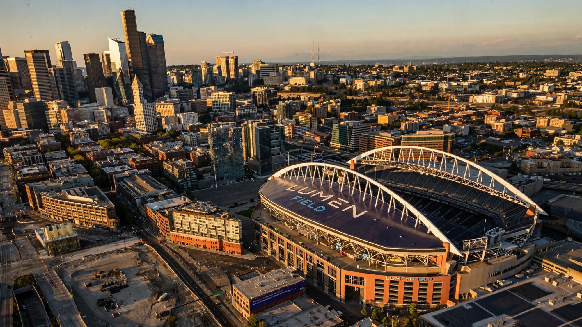 Lumen Field at golden hour with the downtown Seattle skyline behind it